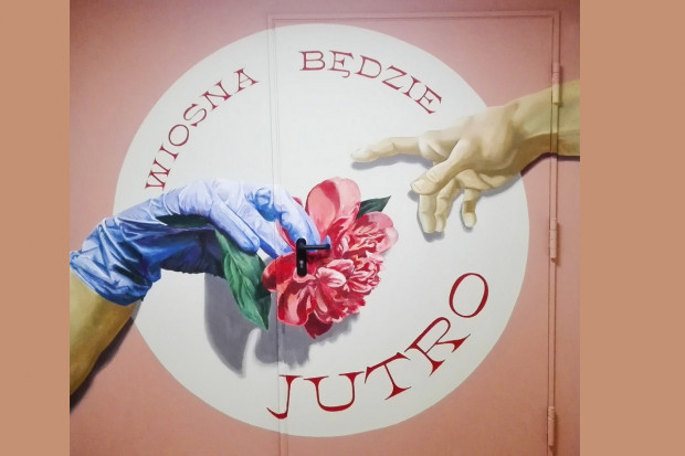 Na jednej ze szpitalnych śluz powstają nowe murale. Ten nawiązuje do „Stworzenia Adama”, słynnego fresku Michała Anioła ze sklepienia Kaplicy Sykstyńskiej (fot. good looking studio) Warszawa: mural na śluzie w szpitalu. Tak artyści wspieraja lekarzy